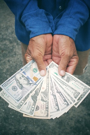 Senior man holding of dollarsの写真素材