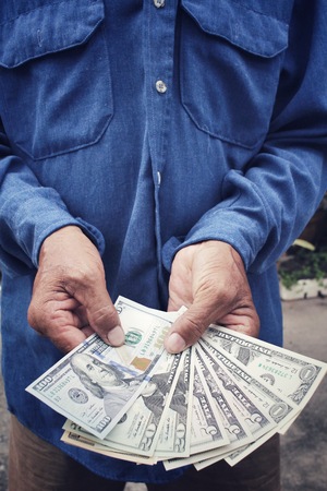 Senior man holding of dollarsの写真素材