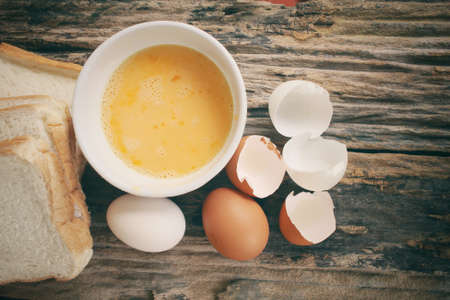 Eggs in a bowl with breadの写真素材