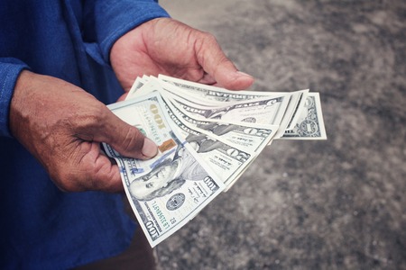 Senior man holding of dollarsの写真素材