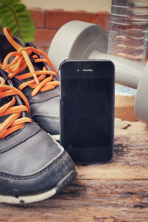 Sports set of sneakers , dumbbells, water drink and smart phoneの写真素材