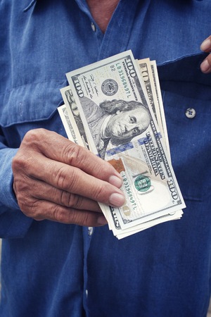 Senior man holding of dollarsの写真素材