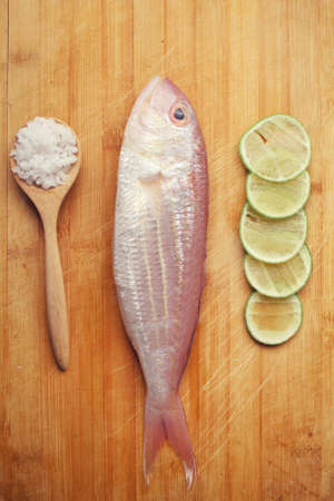 Fresh raw fish ,lemon and saltの写真素材
