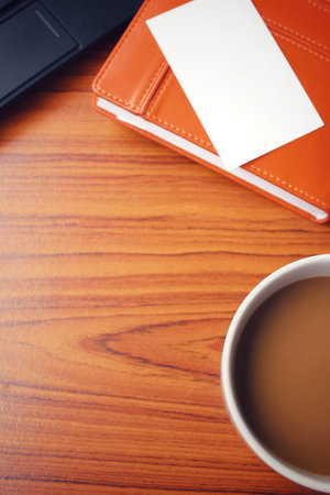Coffee cup with blank business card at officeの写真素材