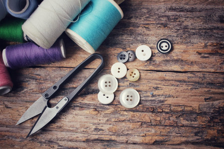 Bobbins colorful threads ,sewing buttons and scissors