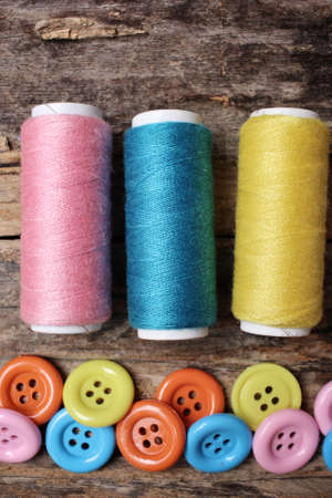 Colorful sewing buttons with threadの写真素材