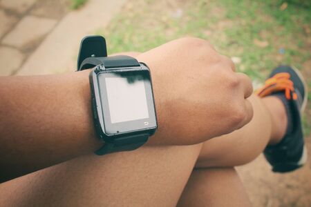 Woman sitting with smartwatchの写真素材