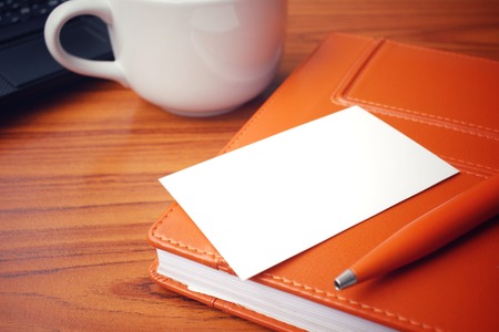 Coffee cup with blank business card at officeの写真素材