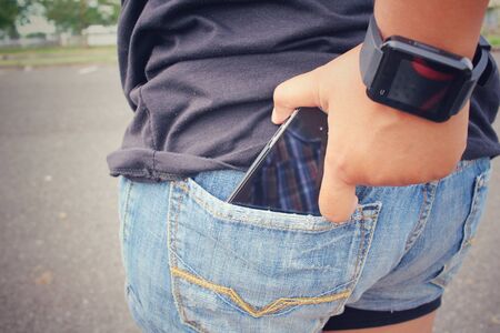 Smart phone in jeans pocketの写真素材