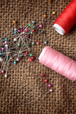 Threads and pins sewing on sackclothの写真素材