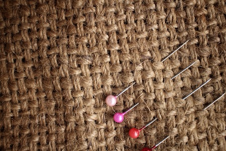 Sewing pins on sackclothの写真素材