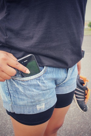 Smart phone in jeans pocketの写真素材