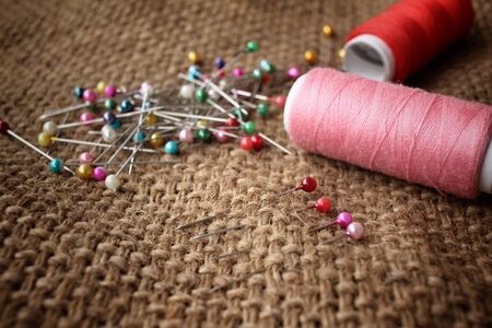Threads and pins sewing on sackclothの写真素材