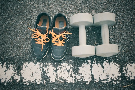 Sports set of sneakers with dumbbellsの写真素材