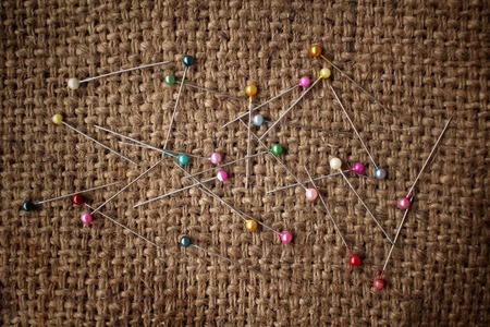 Colorful sewing pins on sackclothの写真素材