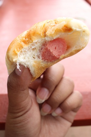 Fast food hot dog with handの写真素材