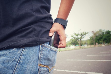 Smart phone in jeans pocketの写真素材