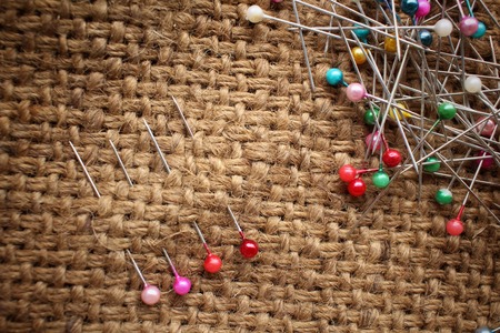 Colorful sewing pins on sackclothの写真素材