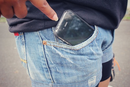 Smart phone in jeans pocketの写真素材