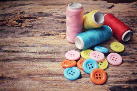 Colorful sewing buttons with thread