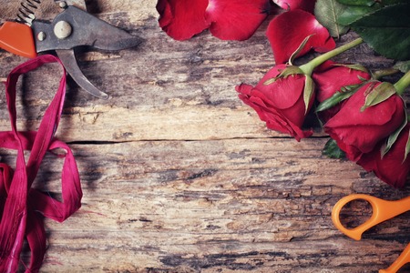 Woman making bouquet with red roses flowerの写真素材
