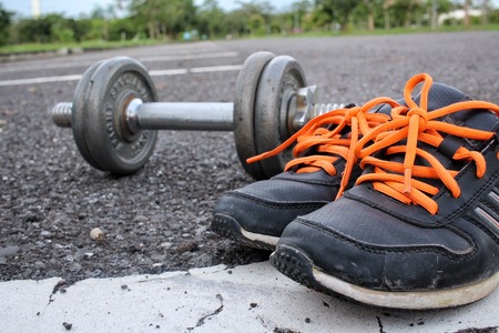 Sports set of sneakers with dumbbellsの写真素材