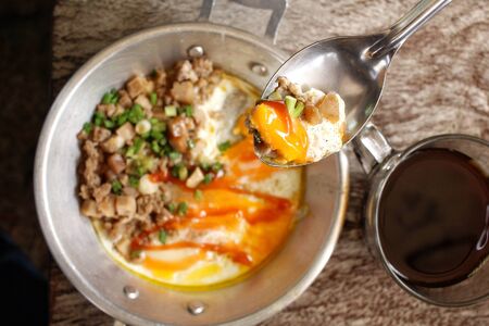 Breakfast with  fried eggs on pan and hot coffeeの写真素材