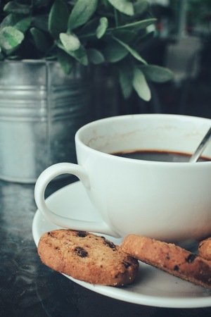 Hot coffee with chocolate cookiesの写真素材