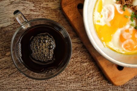 Breakfast with  fried eggs on pan and hot coffeeの写真素材