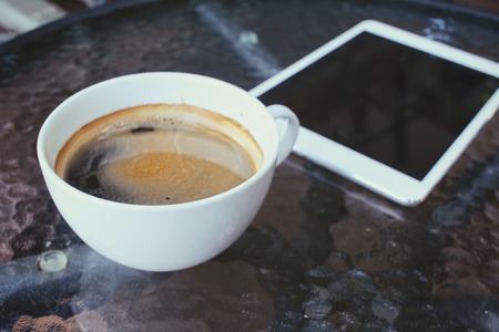 Hot coffee with tabletの写真素材