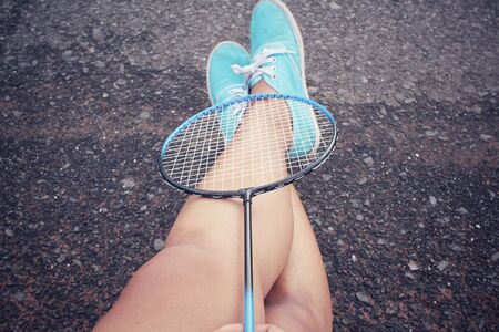 Selfie of sneakers with badminton racket.の写真素材
