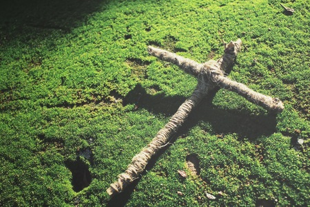 Vintage cross on green mossの写真素材