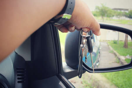 Woman holding keys with carの写真素材