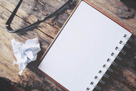 Blank notepad with glasses on office tableの写真素材