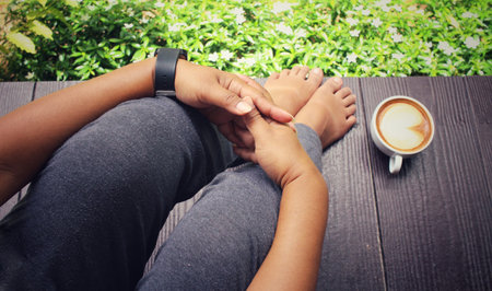 Selfie of coffee with feet in the gardenの写真素材