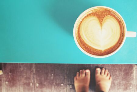 Selfie of coffee with feet at homeの写真素材