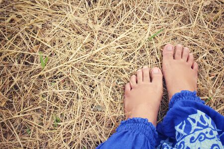 Selfie of feet on dried grassの写真素材