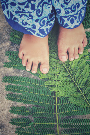 Selfie of feet on leaves