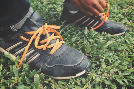 Hands tying shoelacesの写真素材