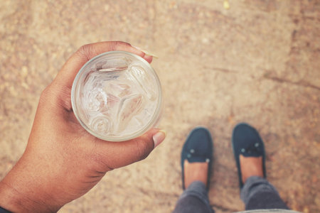 Selfie of drink water on hand with shoes