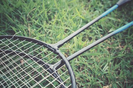 Badminton racket on green grassの写真素材