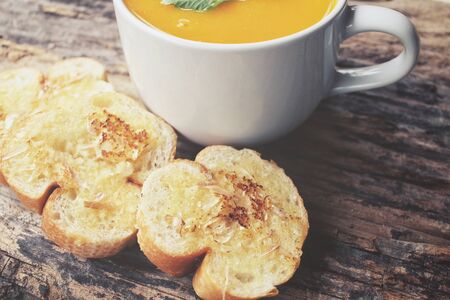 Pumpkin soup with garlic and herb breadの写真素材