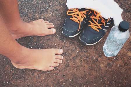 Selfie of feet and sport shoes with water drinkの写真素材