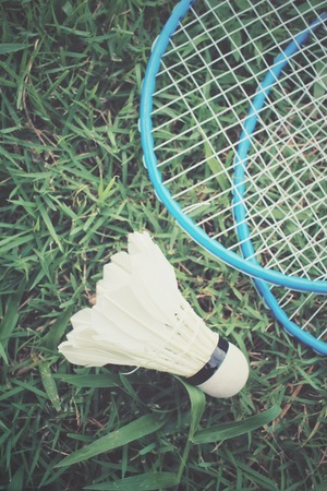 Shuttlecocks with badminton racket on green grassの写真素材