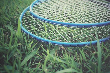Badminton racket on green grassの写真素材