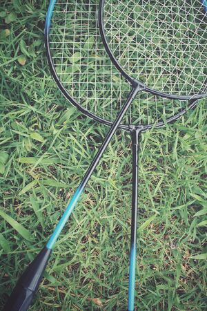 Badminton racket on green grassの写真素材