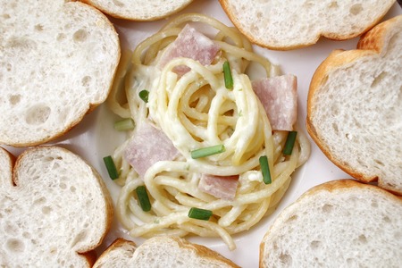 Spaghetti carbonara with french baguetteの写真素材