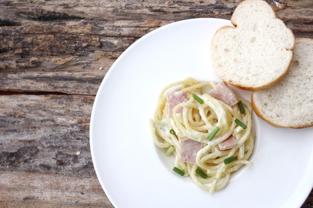 Spaghetti carbonara with french baguetteの写真素材