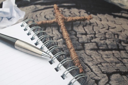 Blank notepad and pen with crossの写真素材