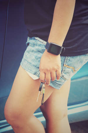 Woman with key car on handの写真素材